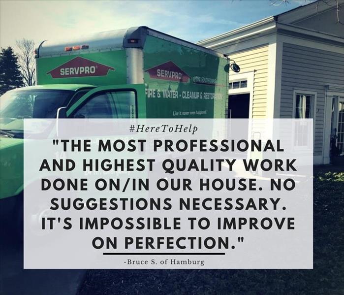 green servpro truck parked in front of house with block of text in front of it